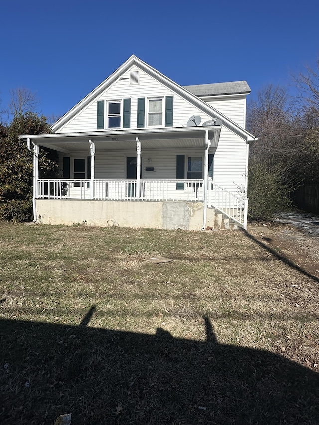 view of front of home featuring covered porch and a front yard