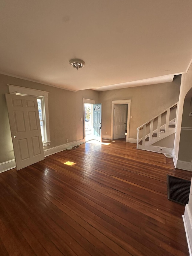 unfurnished living room featuring dark wood-type flooring