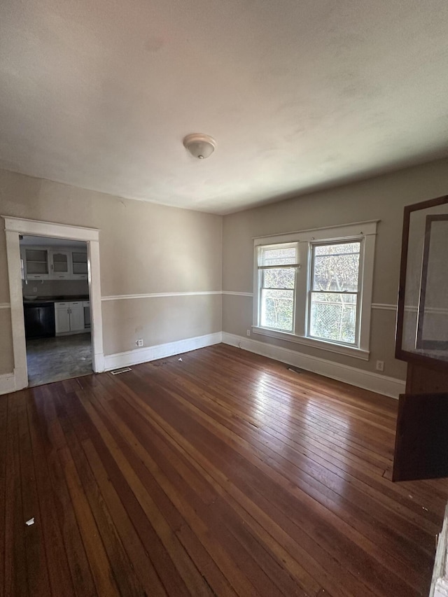 unfurnished living room featuring dark hardwood / wood-style flooring