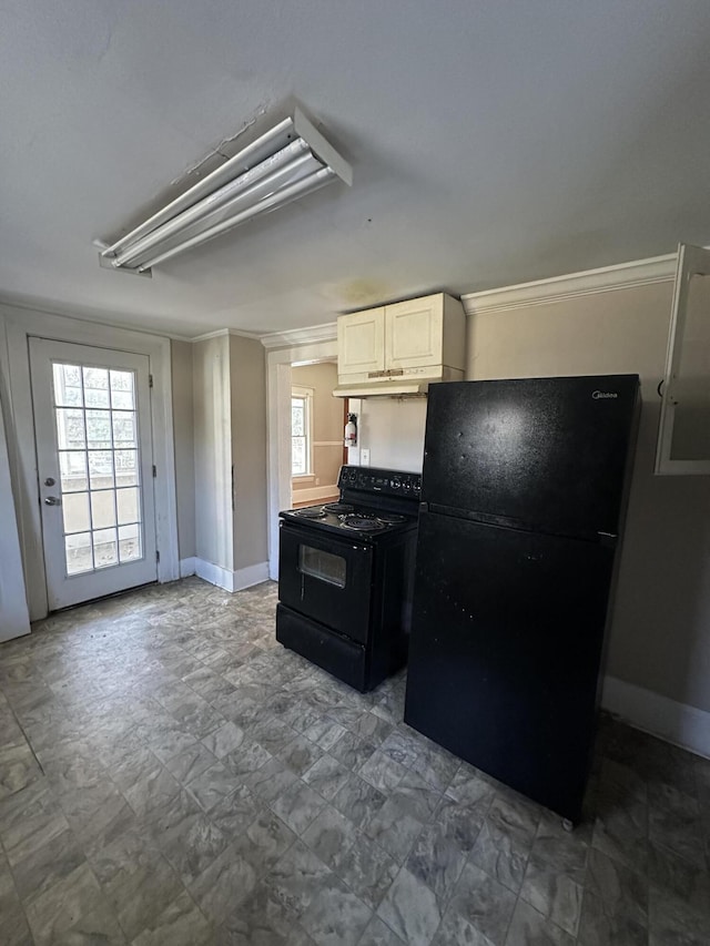 kitchen featuring black appliances, a healthy amount of sunlight, and white cabinetry