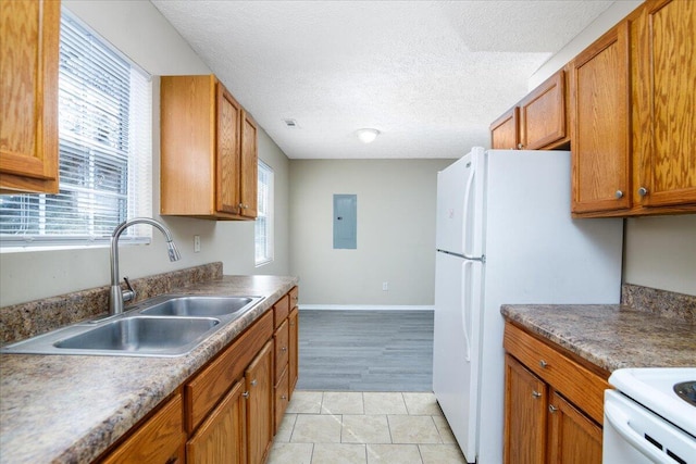 kitchen with sink, white refrigerator, a textured ceiling, electric panel, and light tile patterned flooring