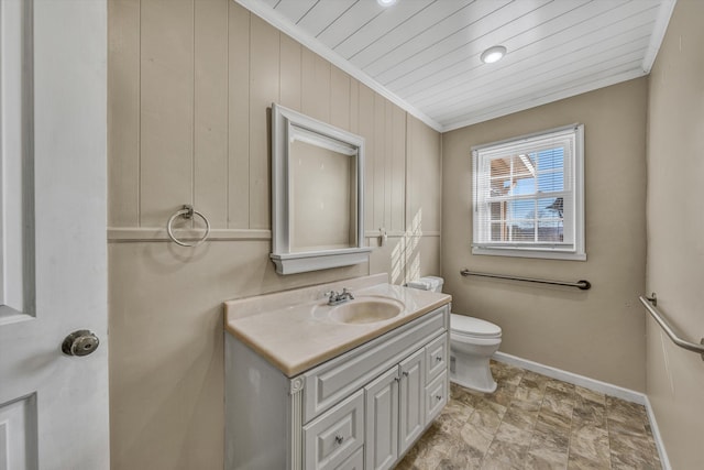 bathroom with toilet, vanity, and crown molding