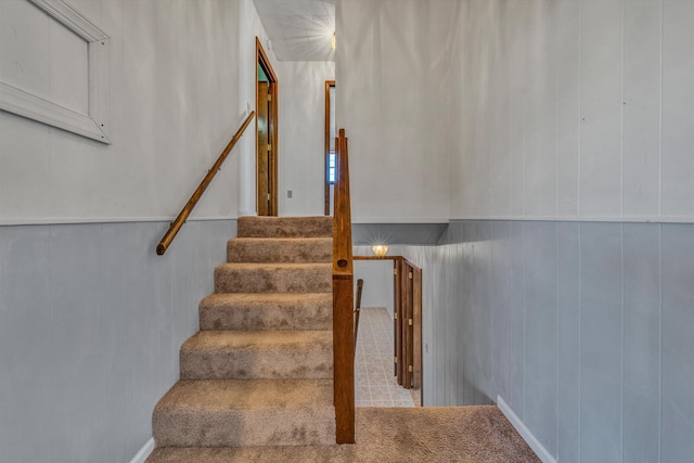 stairs featuring wooden walls