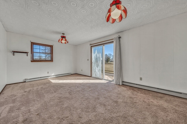 spare room featuring carpet and a baseboard heating unit