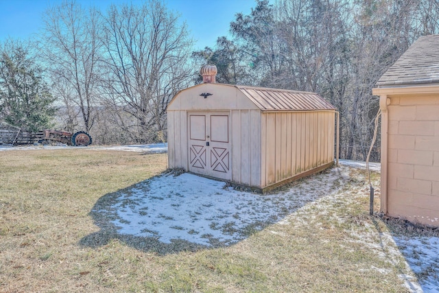 view of outdoor structure featuring a lawn