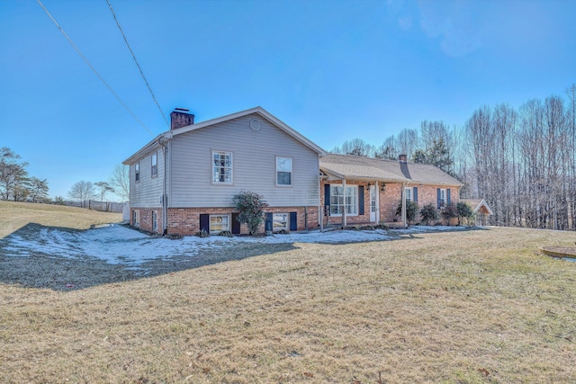 rear view of property featuring a yard