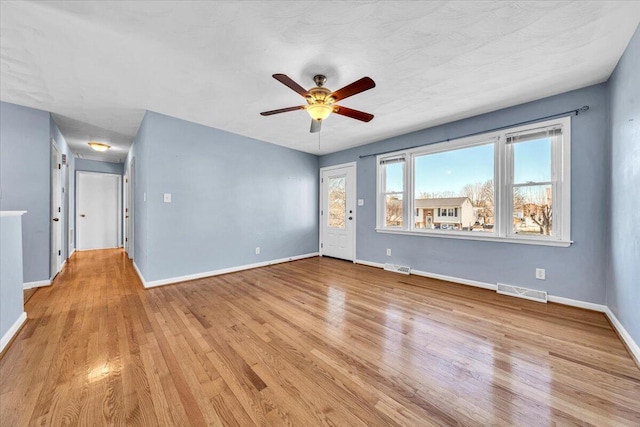 unfurnished room with ceiling fan and light hardwood / wood-style flooring