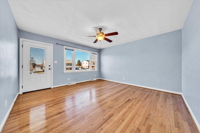 spare room featuring ceiling fan and light hardwood / wood-style floors