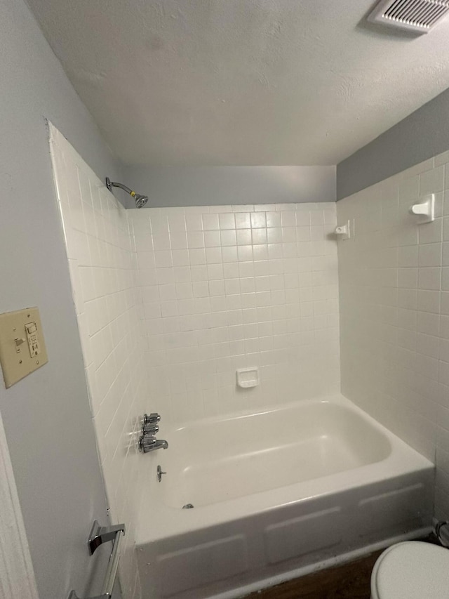 bathroom with toilet and bathtub / shower combination