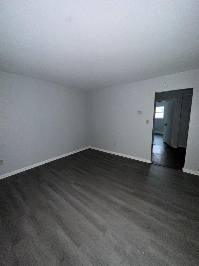 empty room featuring dark wood-type flooring