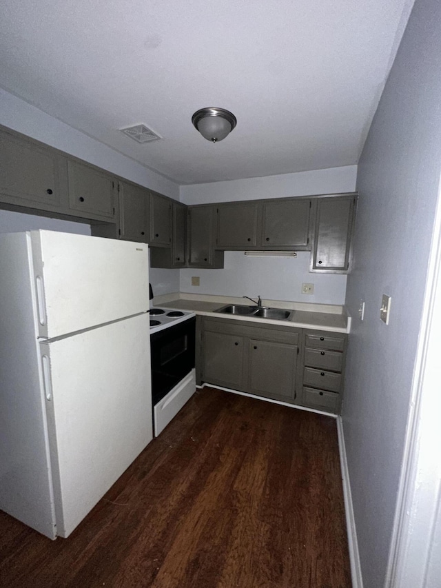 kitchen featuring gray cabinets, white refrigerator, range with electric cooktop, and sink