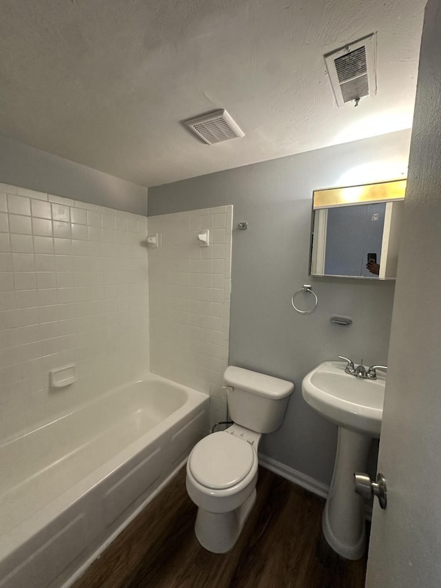 full bathroom with toilet, shower / bath combination, wood-type flooring, and sink