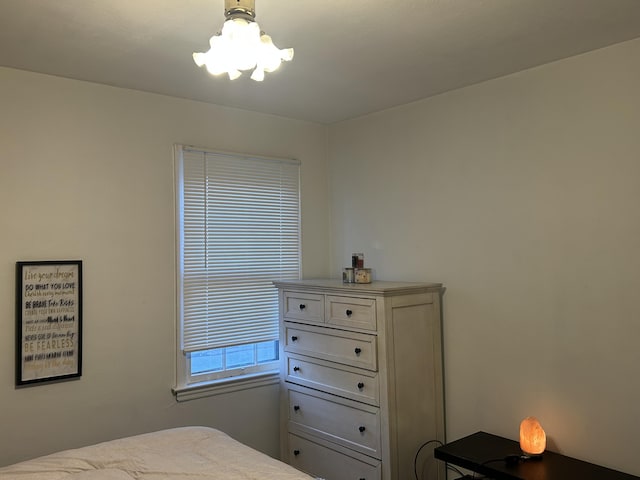 bedroom featuring a notable chandelier