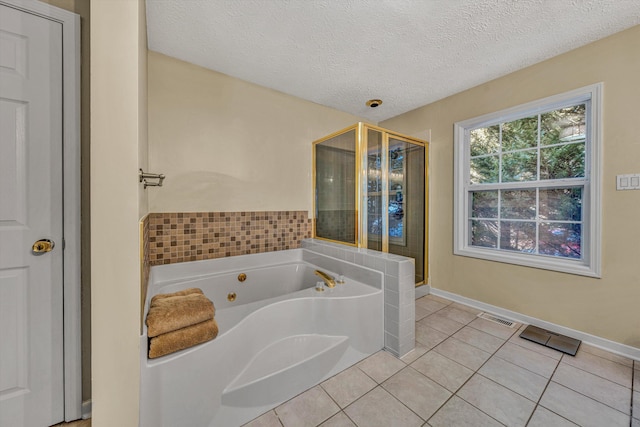 bathroom featuring a textured ceiling, tile patterned flooring, and plus walk in shower