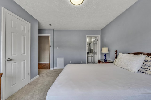 carpeted bedroom featuring a textured ceiling