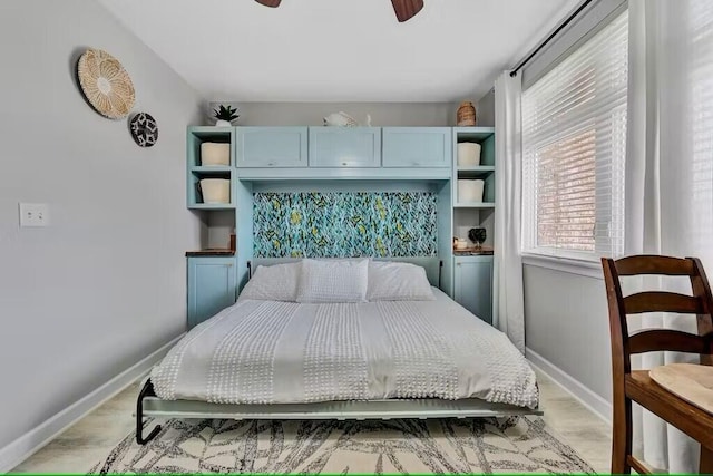 bedroom with ceiling fan and light hardwood / wood-style floors