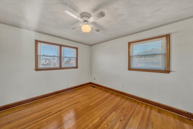 unfurnished sunroom with ceiling fan, a wall unit AC, and wooden ceiling