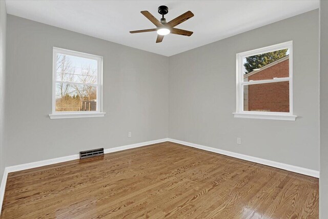 unfurnished sunroom with ceiling fan