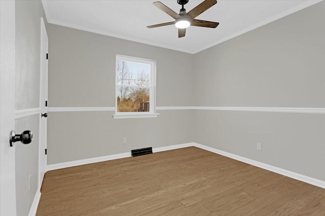 spare room featuring ceiling fan, ornamental molding, and hardwood / wood-style flooring