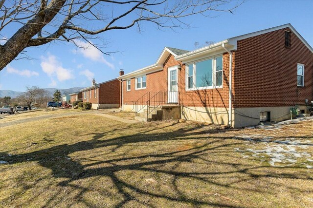 rear view of house featuring a sunroom and central AC unit