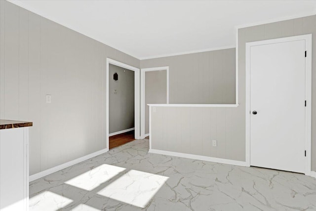 empty room featuring wooden walls and ornamental molding