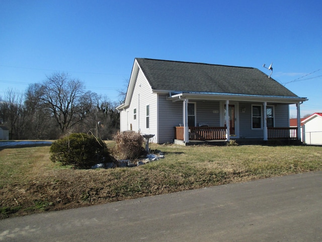 bungalow-style home with covered porch and a front lawn