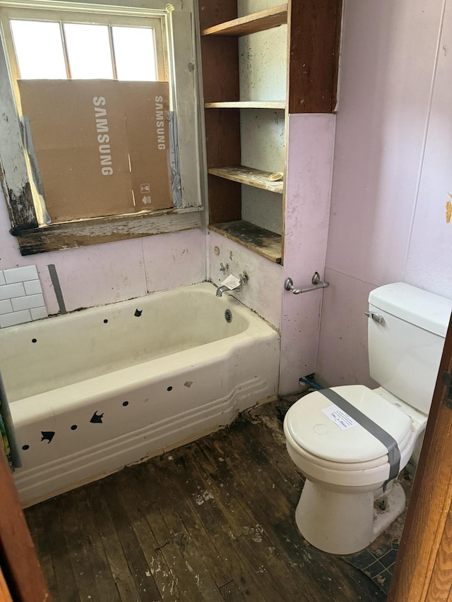 bathroom featuring a bathtub, toilet, and hardwood / wood-style flooring