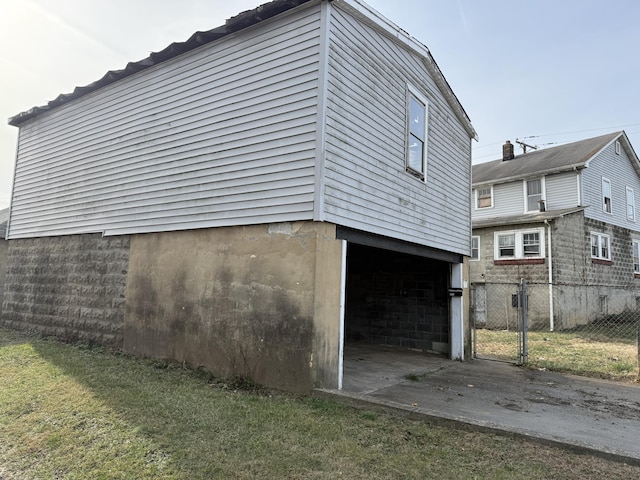 view of property exterior with a lawn and a garage