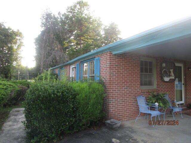 view of side of home with a patio area