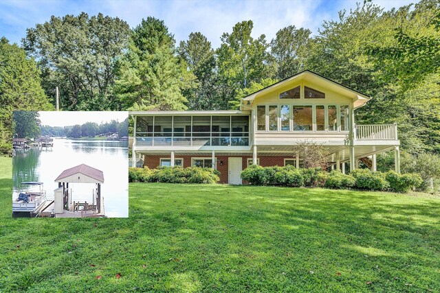 rear view of property with a sunroom and a yard