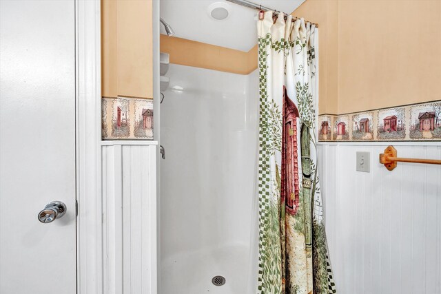 bathroom with walk in shower and tile patterned flooring