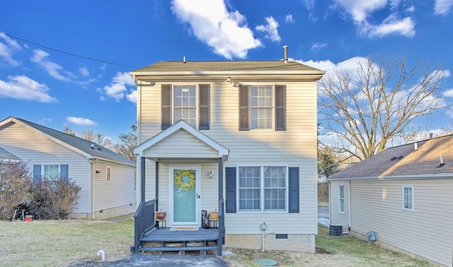 view of front of home with a front yard and central AC unit