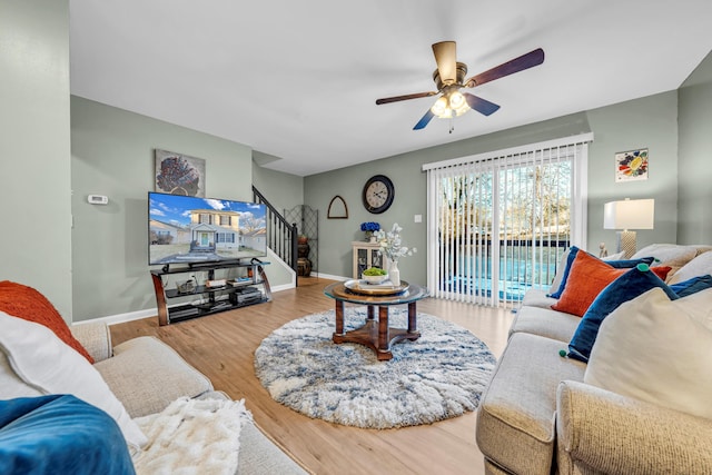 living room with ceiling fan and hardwood / wood-style flooring