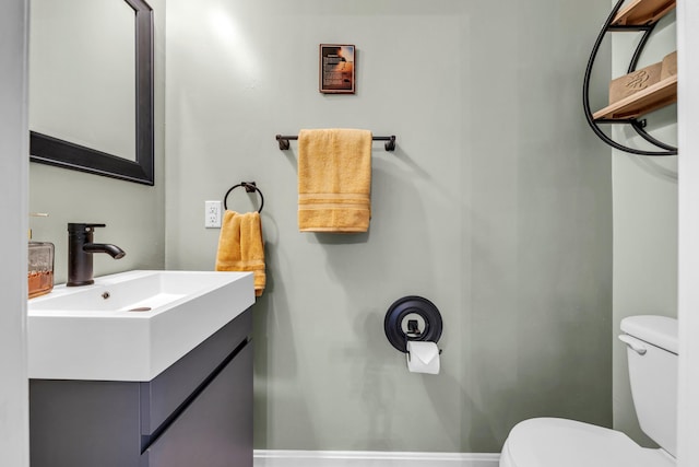 bathroom with toilet and vanity