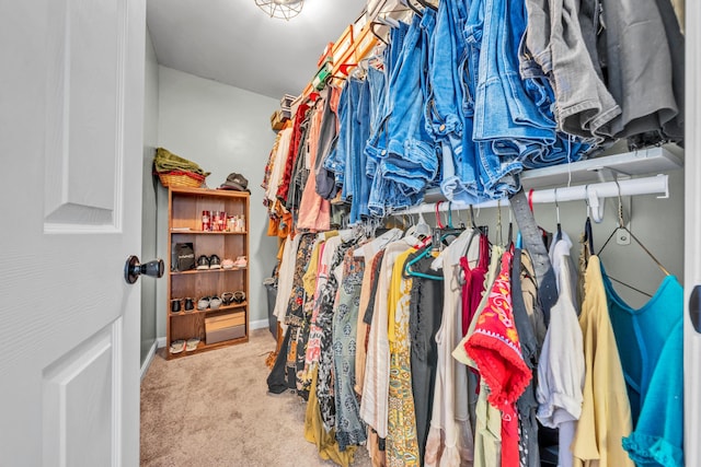 walk in closet featuring light colored carpet