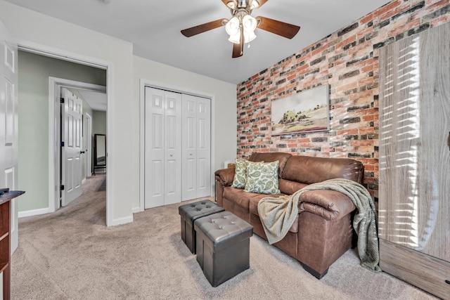 carpeted living room featuring ceiling fan