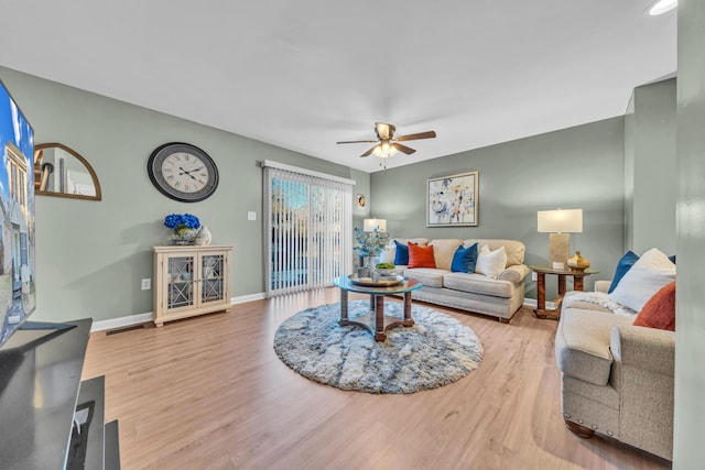 living room featuring ceiling fan and hardwood / wood-style floors