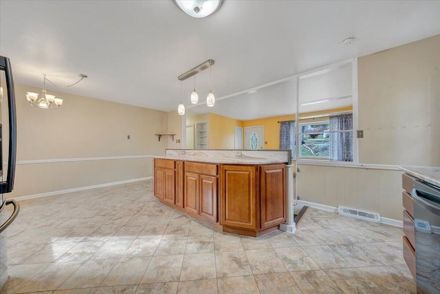 kitchen with dishwashing machine, hanging light fixtures, and a notable chandelier