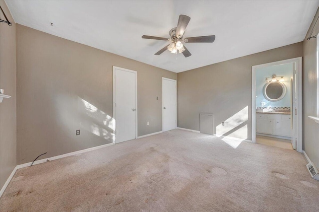 carpeted spare room with ceiling fan and sink