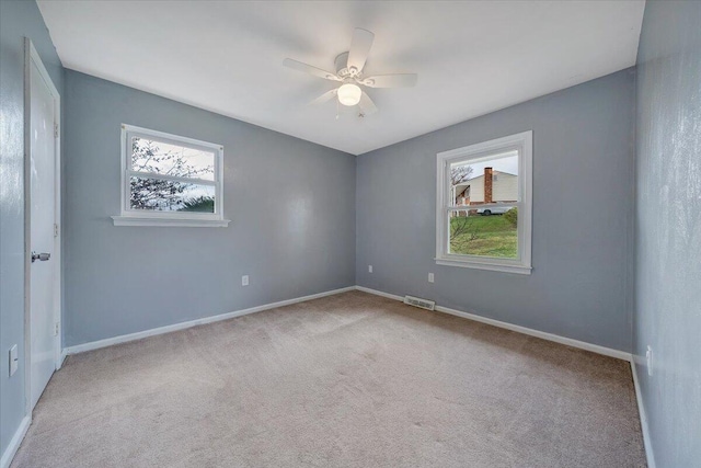 carpeted empty room with ceiling fan