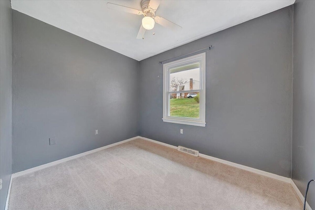 spare room featuring ceiling fan and carpet flooring