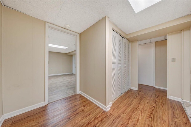 hallway with light hardwood / wood-style floors