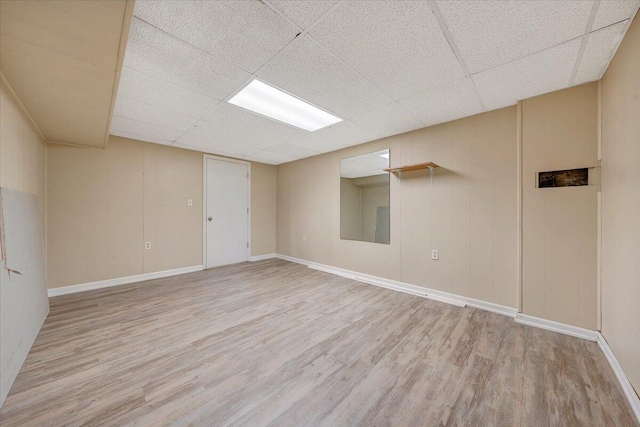 interior space featuring a drop ceiling and hardwood / wood-style floors