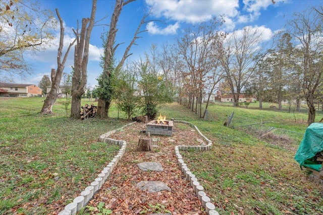 view of yard with a fire pit