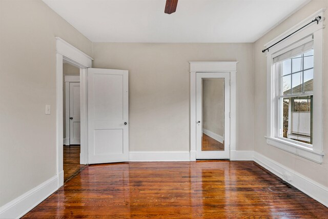 unfurnished bedroom with ceiling fan and dark hardwood / wood-style flooring