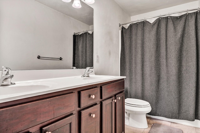 bathroom featuring toilet, tile patterned floors, and vanity