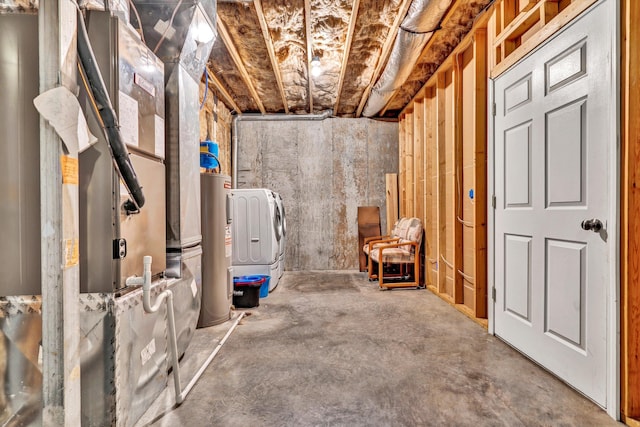 basement with water heater and washer / clothes dryer