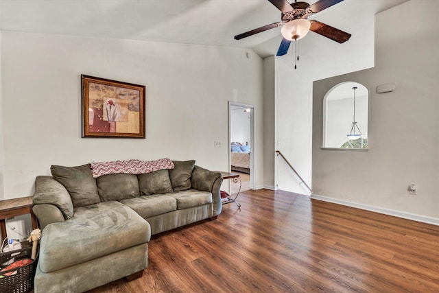 living room featuring vaulted ceiling, ceiling fan, and dark hardwood / wood-style flooring