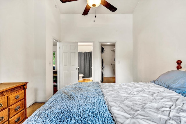 bedroom featuring ceiling fan, ensuite bath, carpet flooring, a walk in closet, and a closet