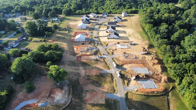 drone / aerial view featuring a residential view and a view of trees